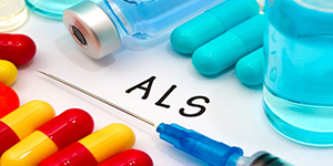 pills, needle and drug containter on table with ALS in text
