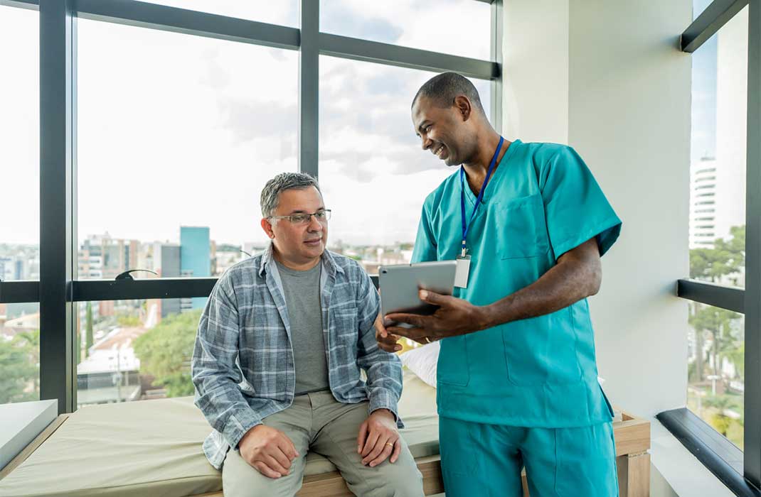 Doctor showing a tablet to patient