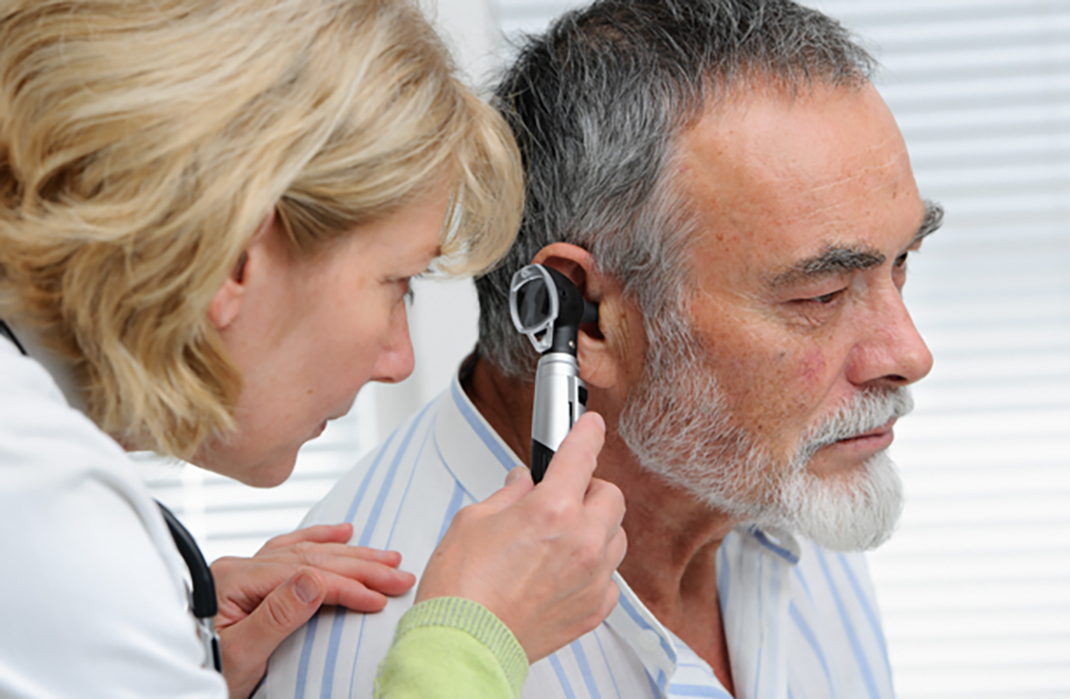 Provider looks in patient's ear