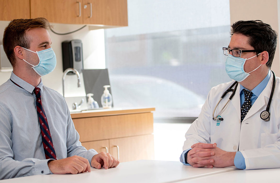 Two medical professionals sit at a table together