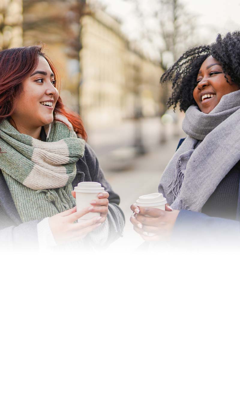 Two women enjoying coffee outdoors
