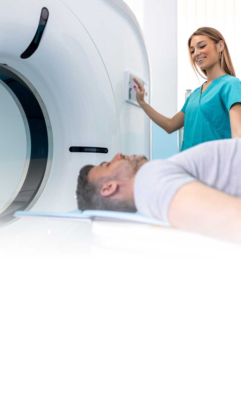 female clinician preparing a man for an MRI