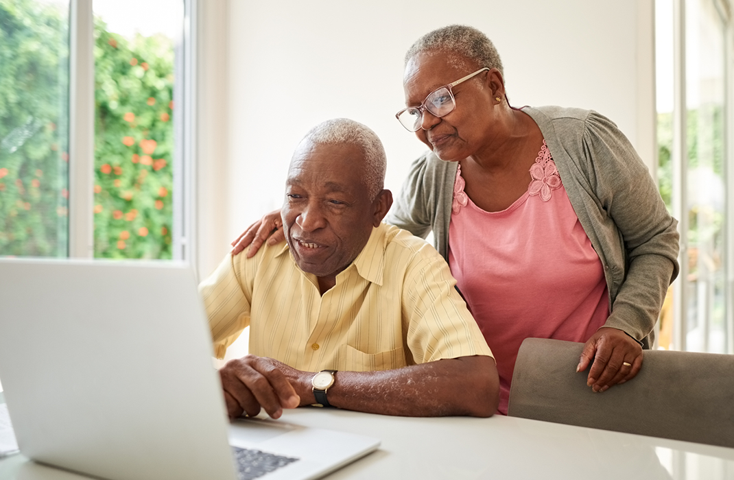 man and woman at laptop at home
