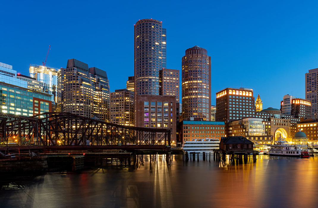 Boston skyline at night in front of Charles River