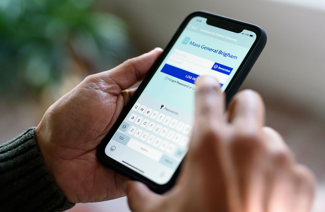 Hand with Patient Gateway login screen on phone