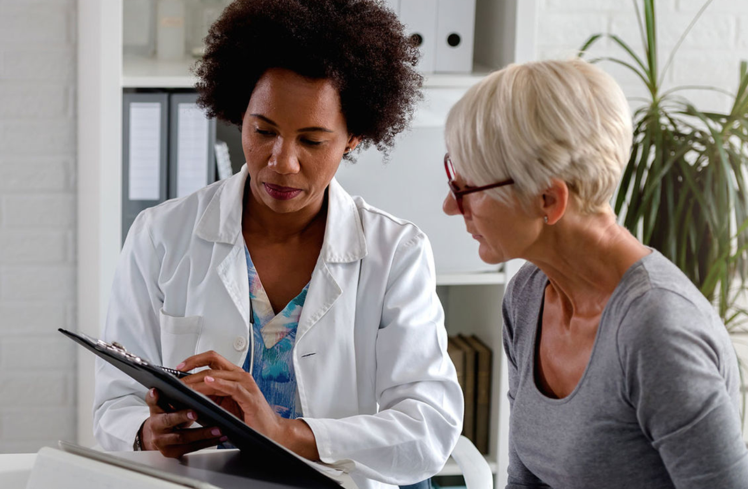 female provider reviewing chart with patient