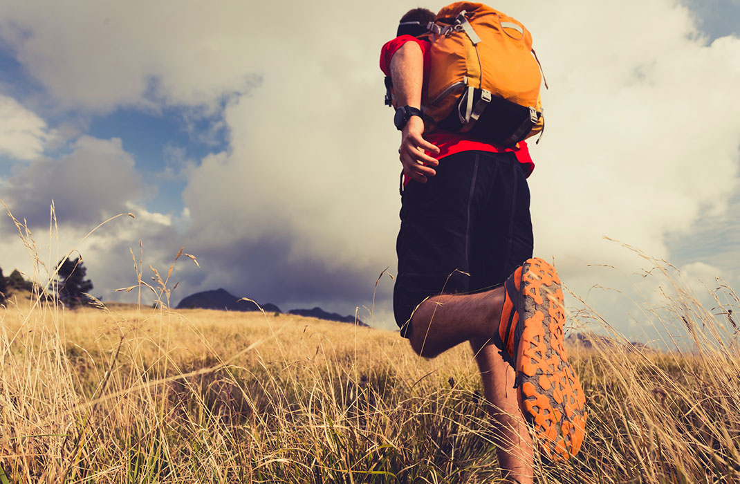 man hiking with backpack outdoors