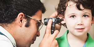 physician examining child's ear