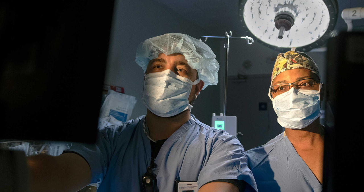 female clinician with mask and face shield in hallway