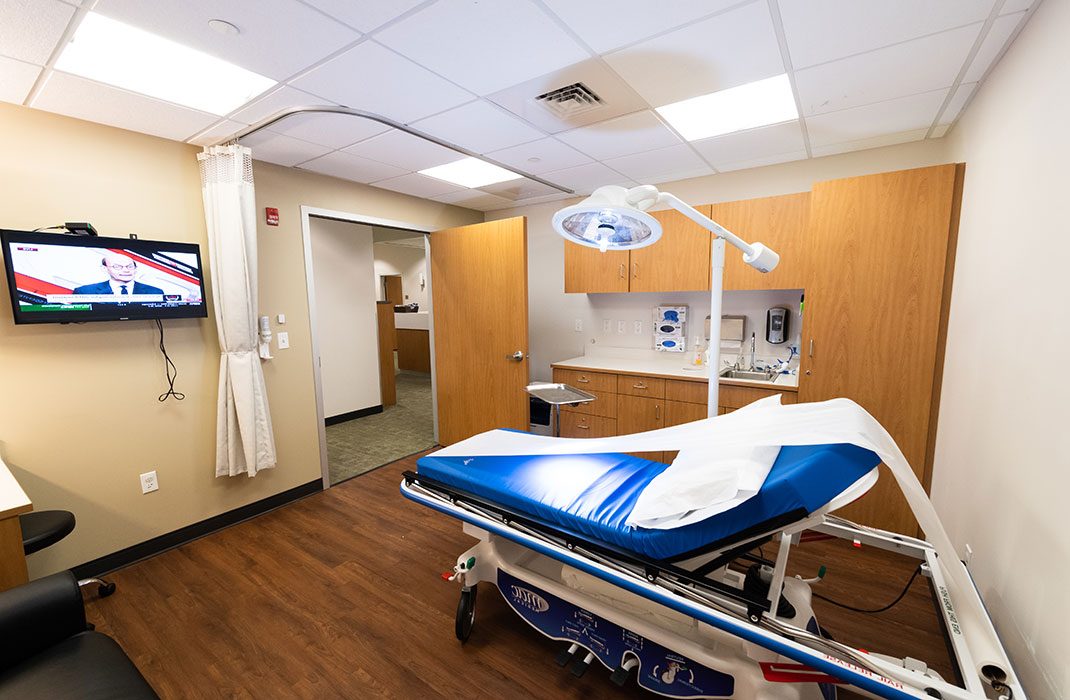 Urgent care exam room with chair.