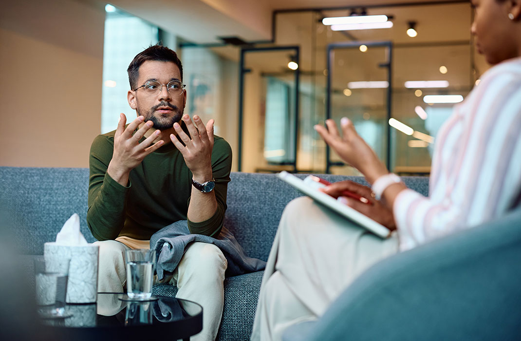 An anxious-looking man having a session with his therapist.