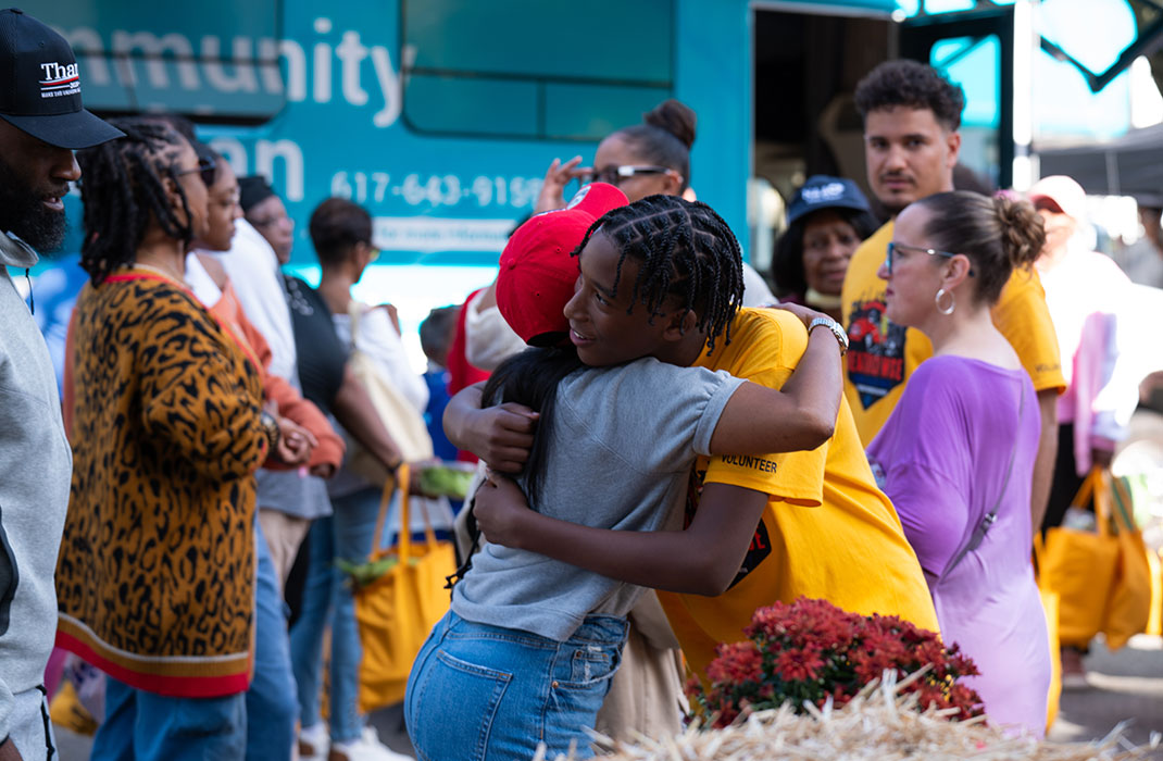 Two people hug at a community block party