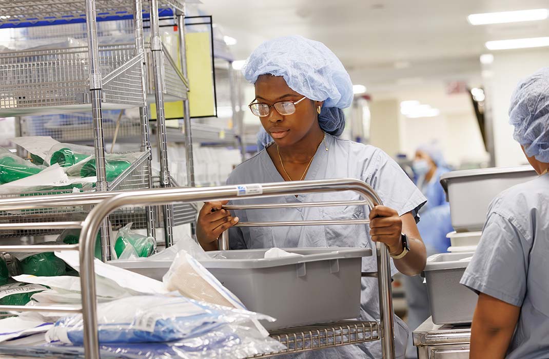 female student in scrubs in laboratory setting