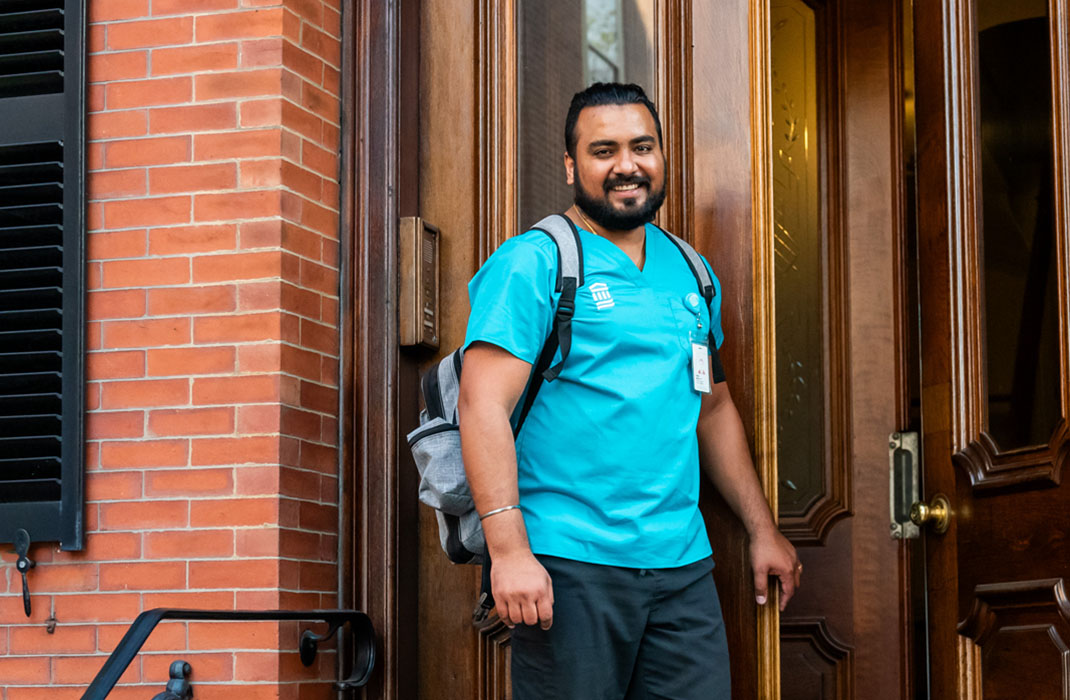 male medical provider at door of patient's home