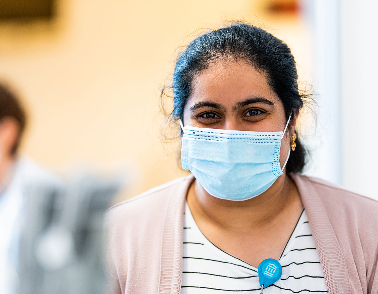 Woman of color wearing a mask