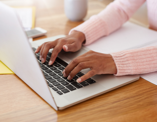 person typing on laptop keyboard