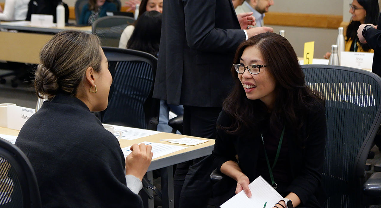 Two participants from the 2023 Commercialization and Inclusive Leadership Program event chat with each other