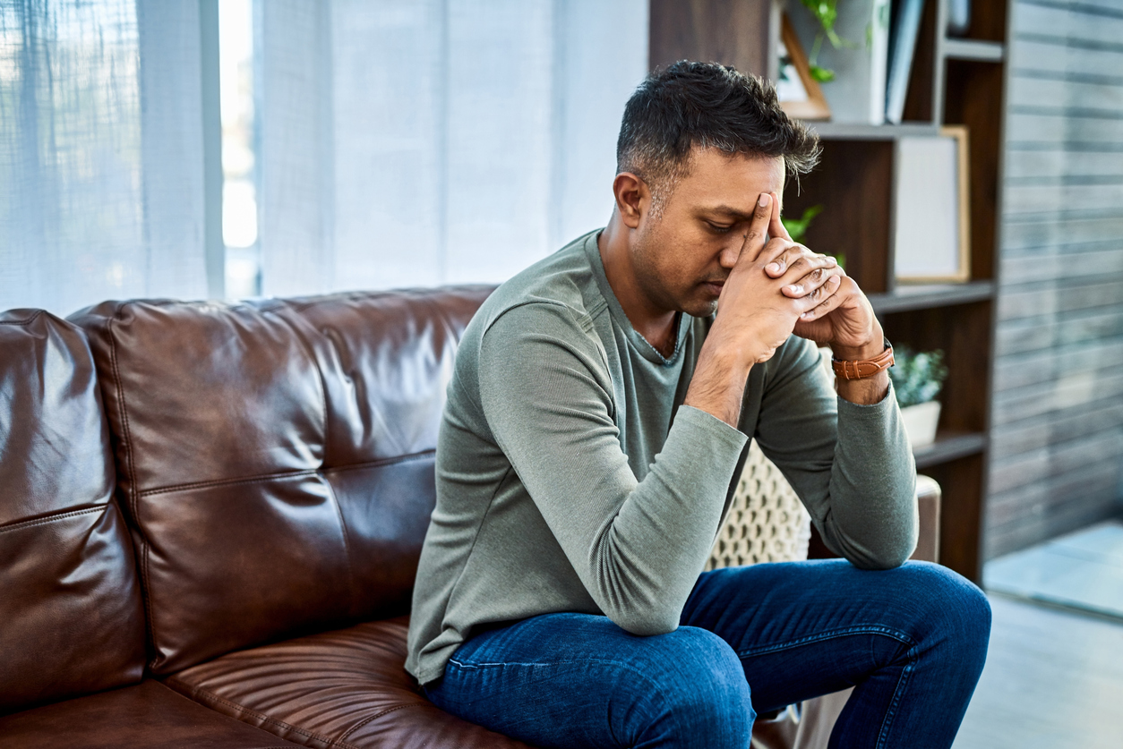 A man experiences symptoms of anxiety at home.