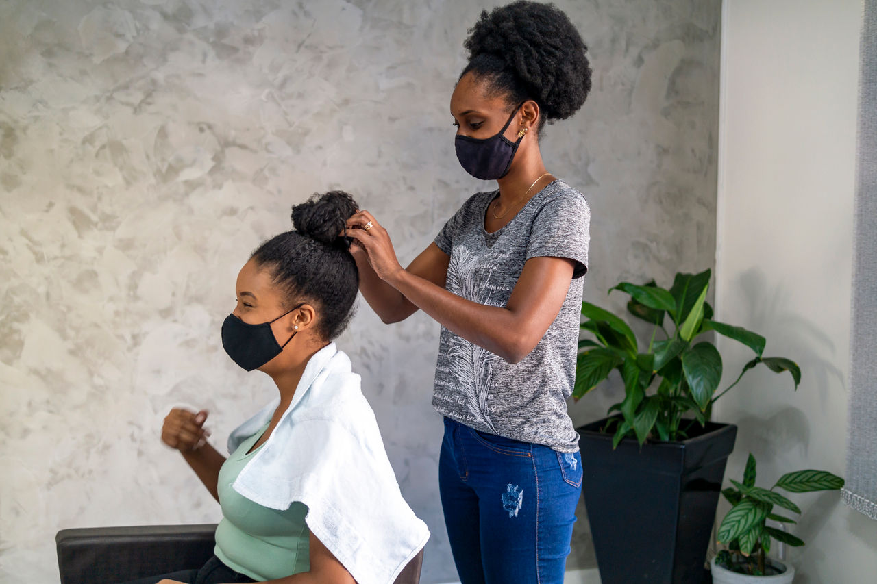 Young woman gets hair done at salon.