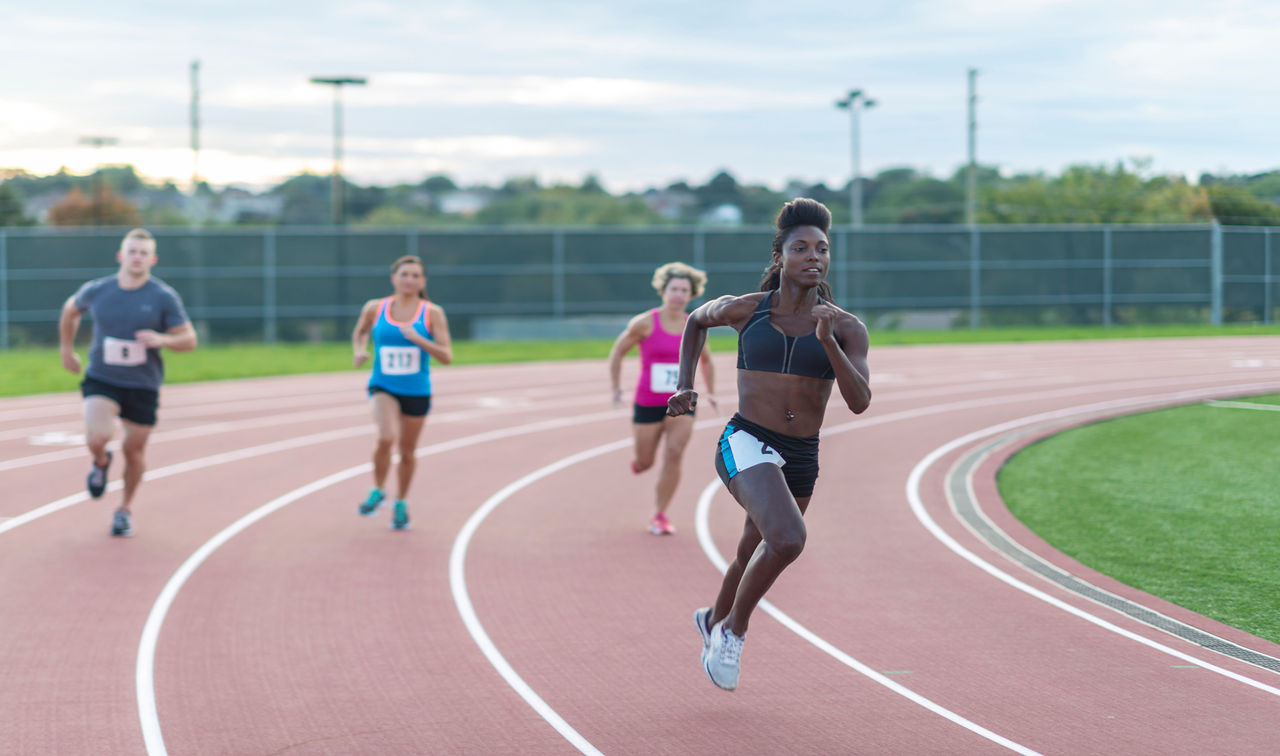Female athletes run on a track