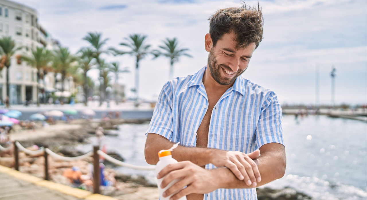 A man applying sunscreen A man applying sunscreen