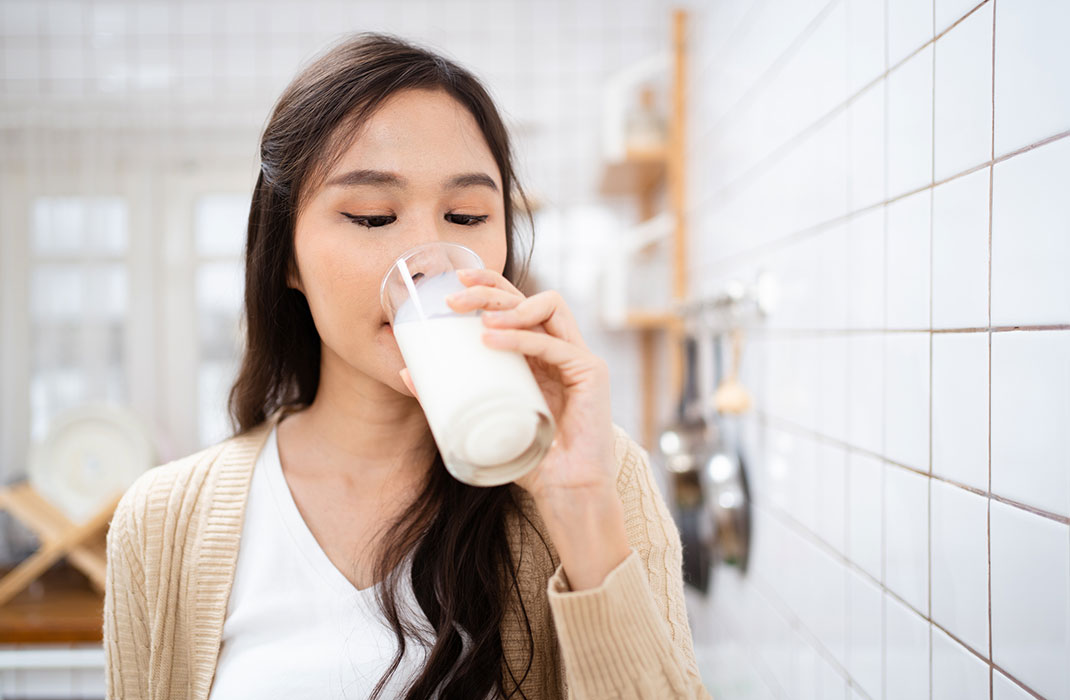Woman drinking a glass of milk. 