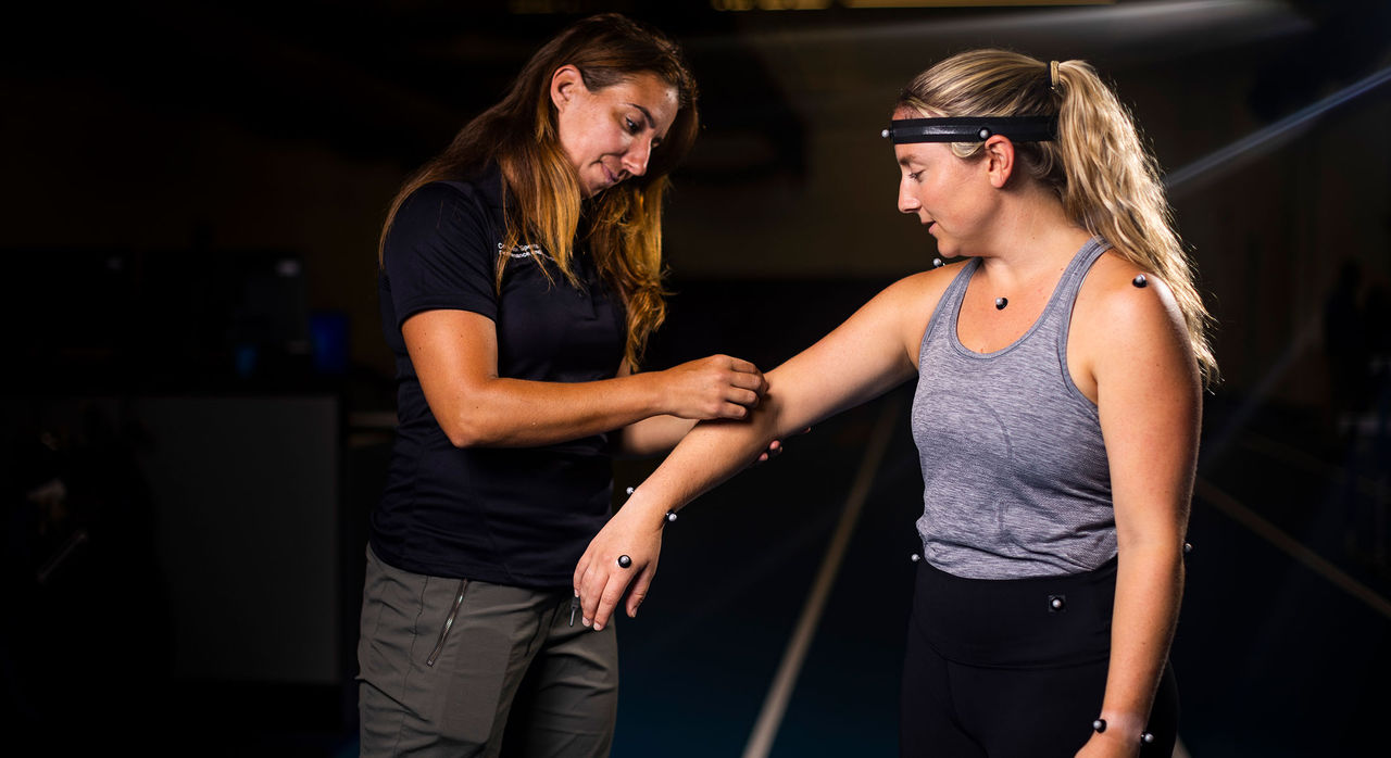 Beth Wilcox, PhD performs biomechanic research with an athlete.