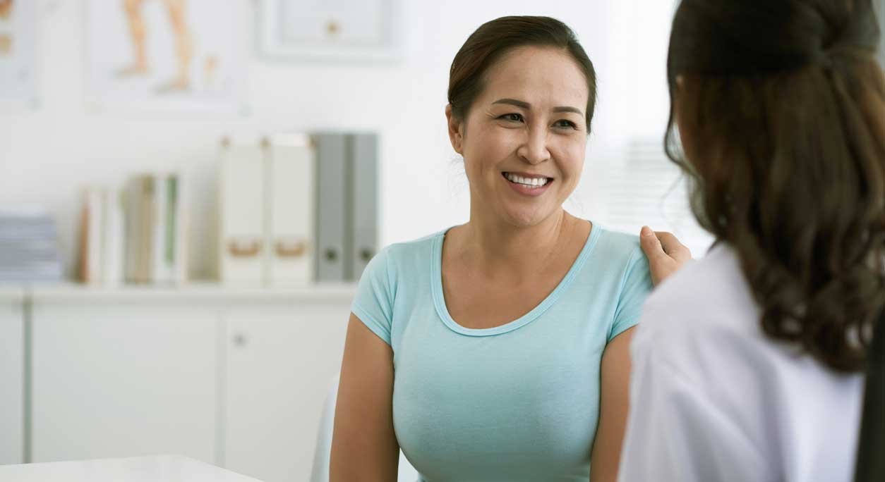 A smiling patient with her doctor.