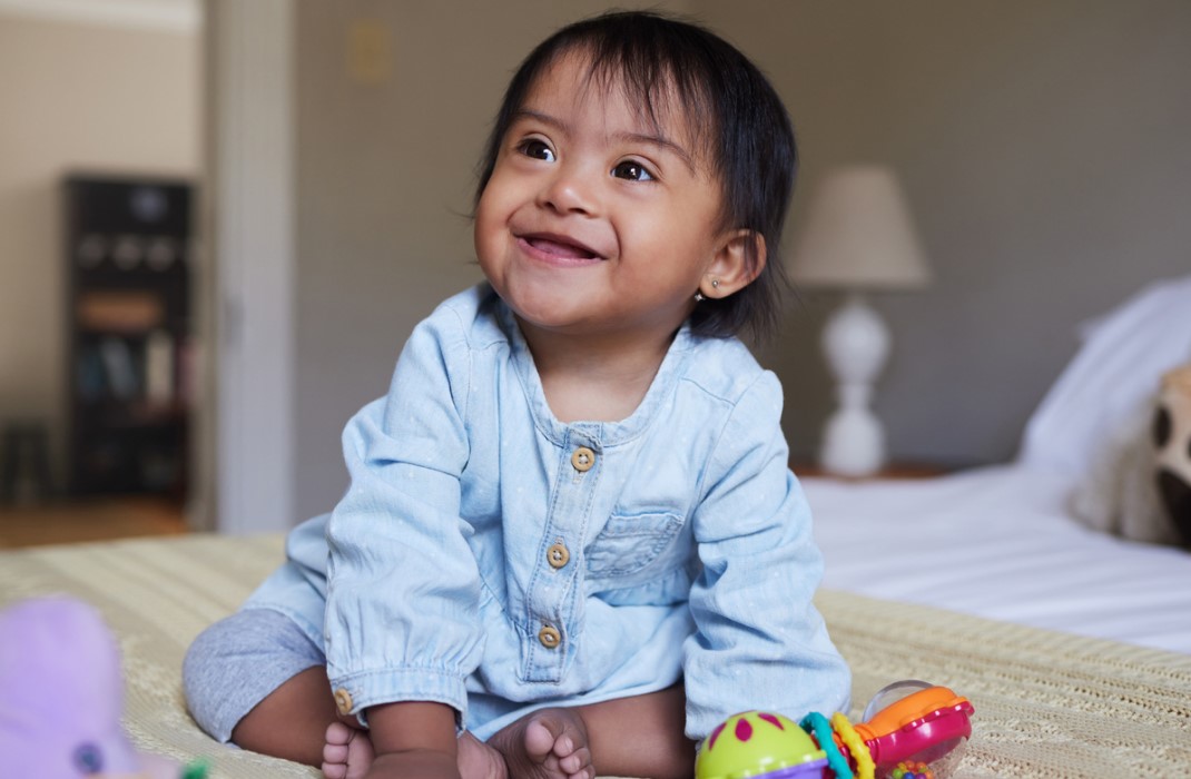 A happy baby with Down syndrome.