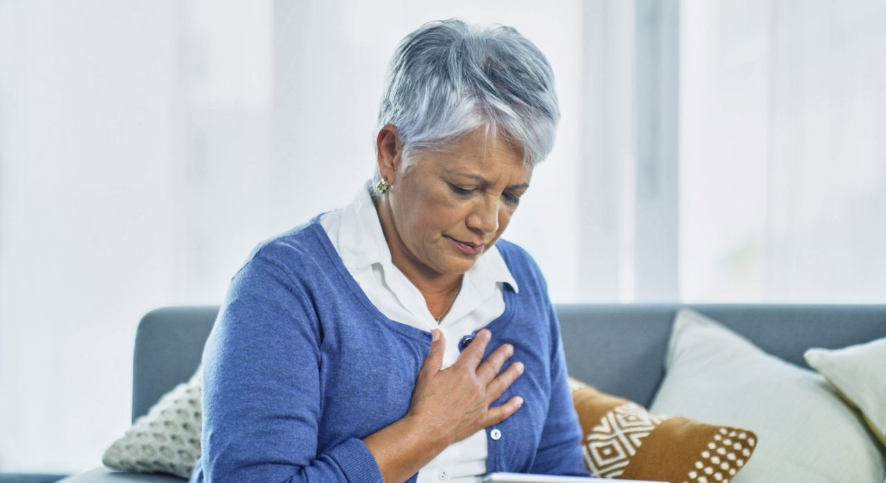 A woman experiencing moderate chest pain