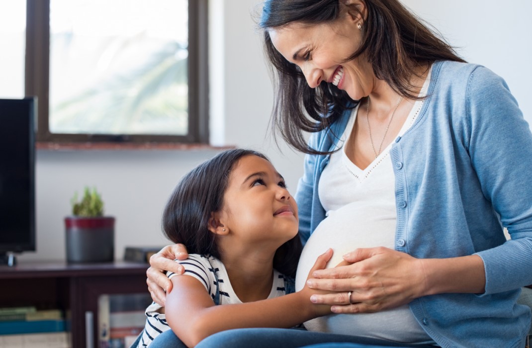 Pregnant person and daughter