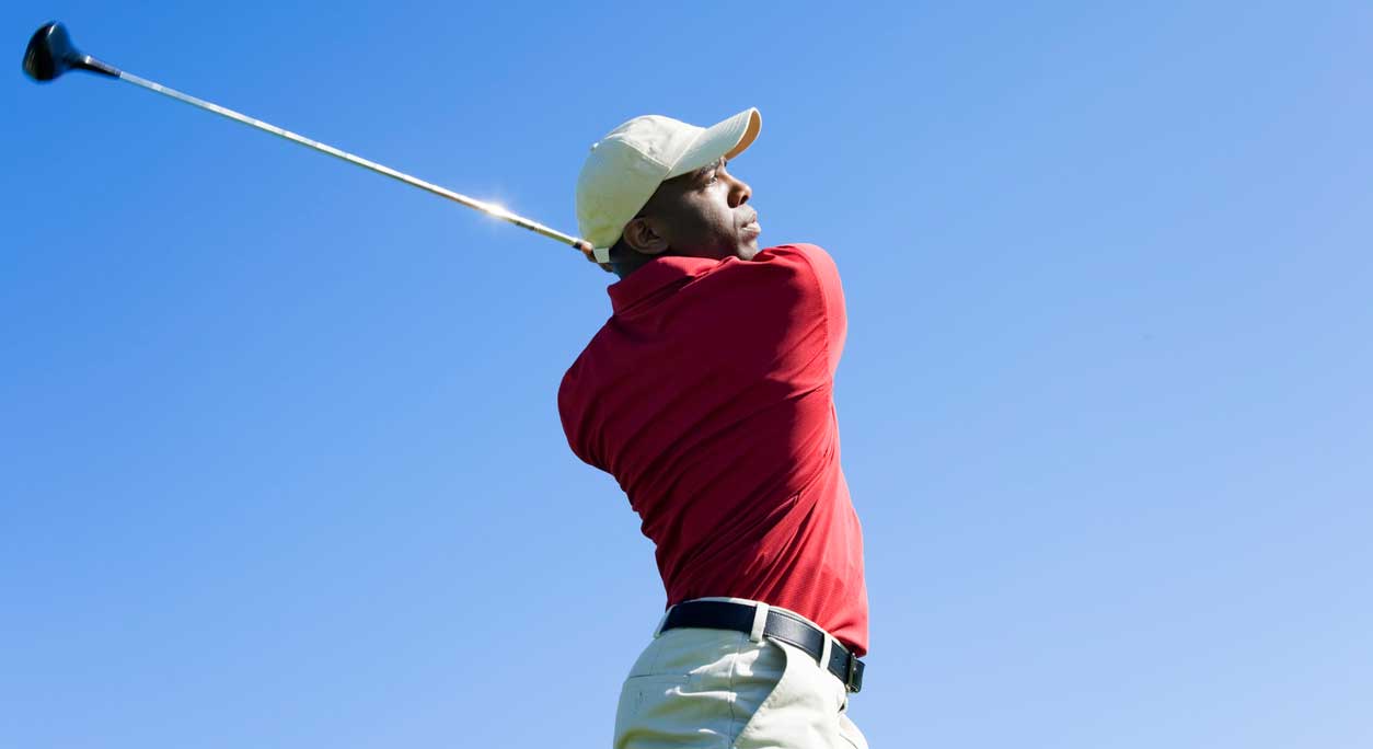 A man finishes a golf swing.