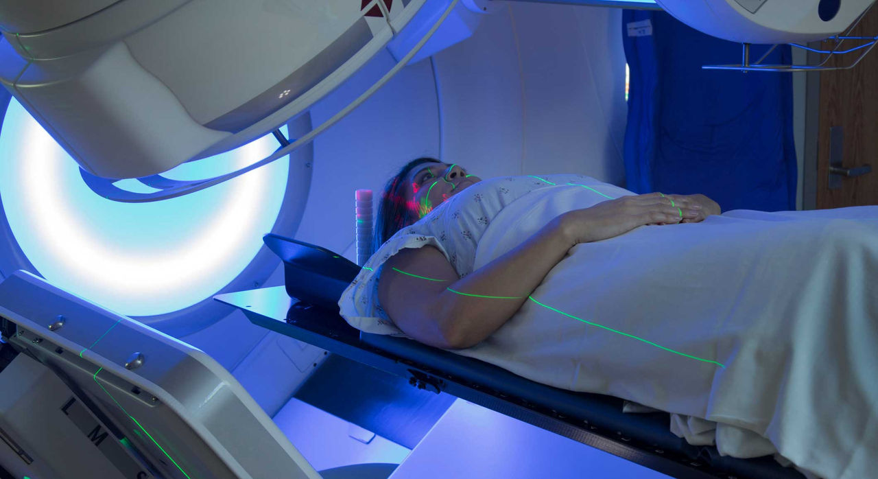 A patient lying in a radiotherapy machine.
