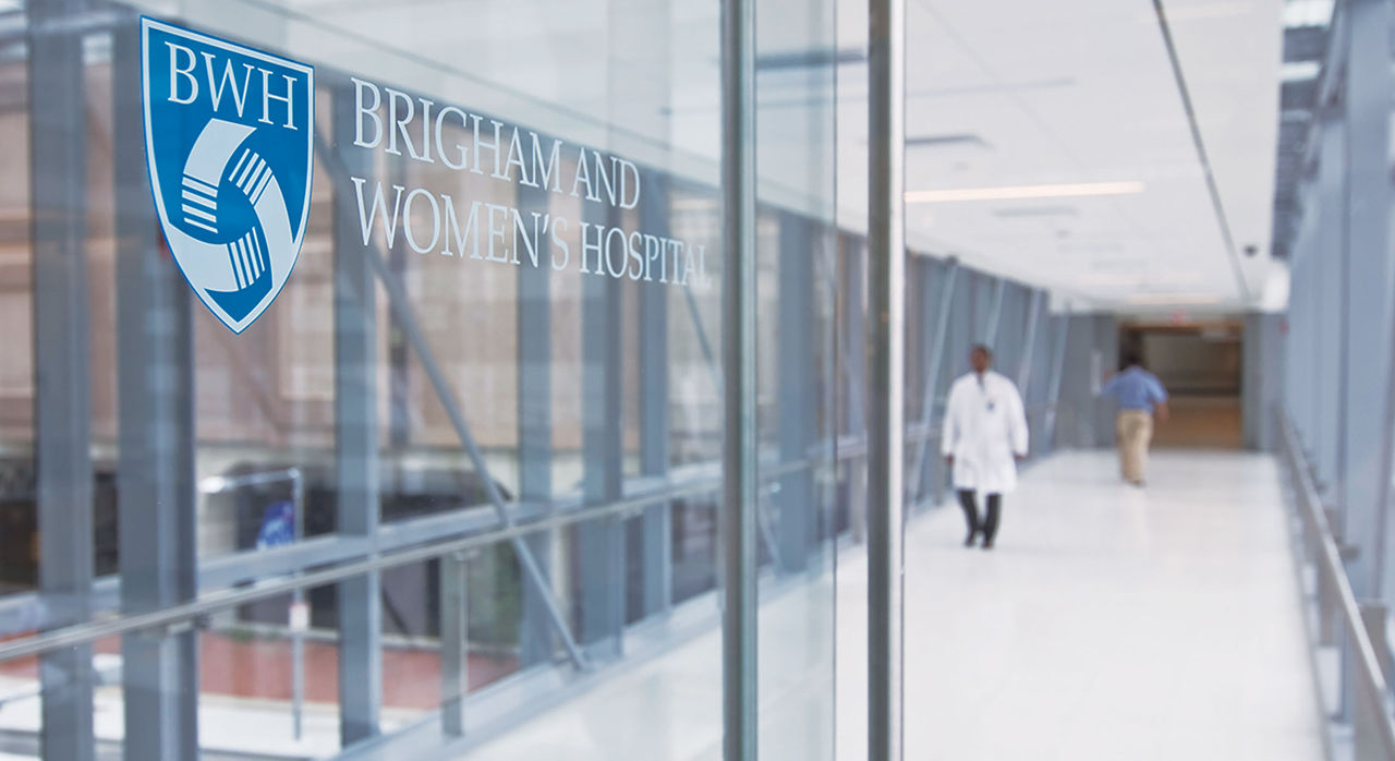 Brigham and Women's Hospital sign on a glass door in the walkway