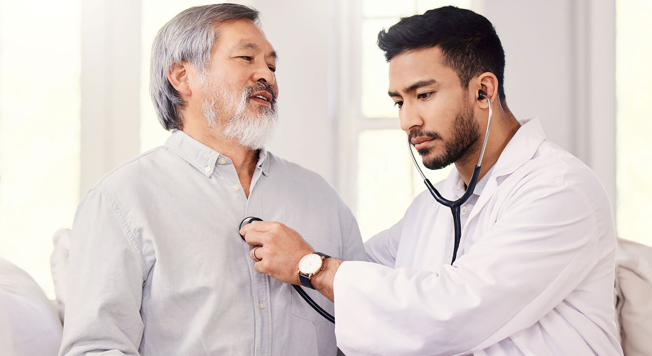 A cardiologist examines a patient