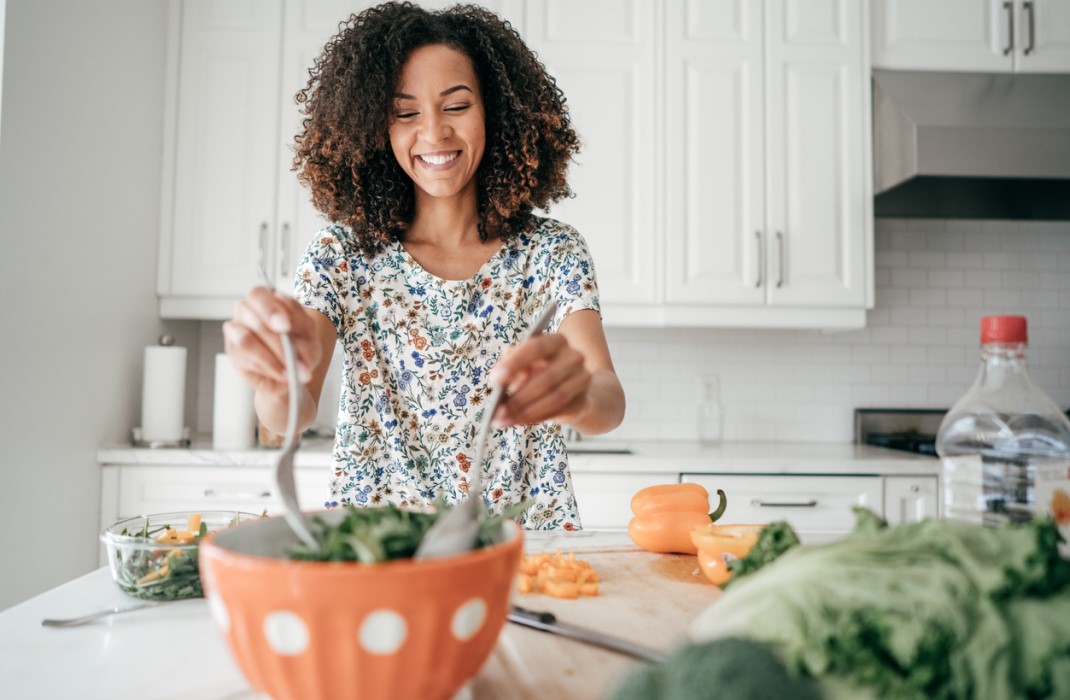 Woman prepares salad