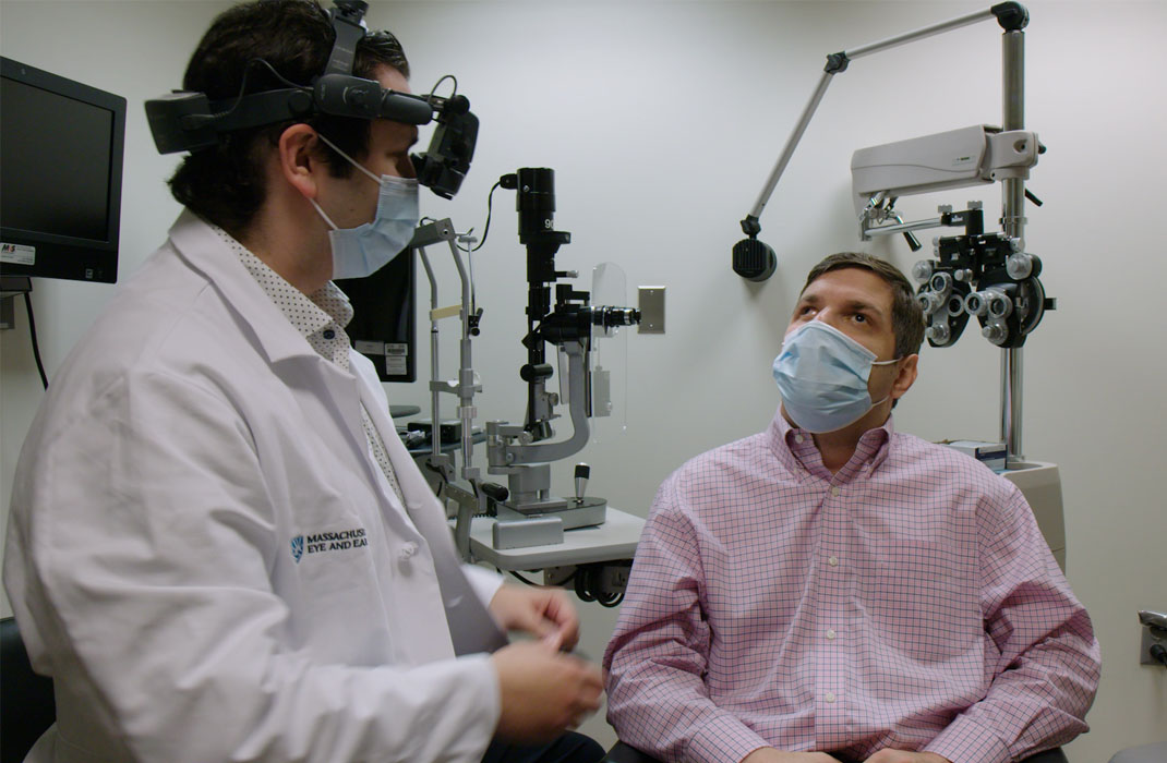 Mass Eye and Ear doctor with patient in eye exam room