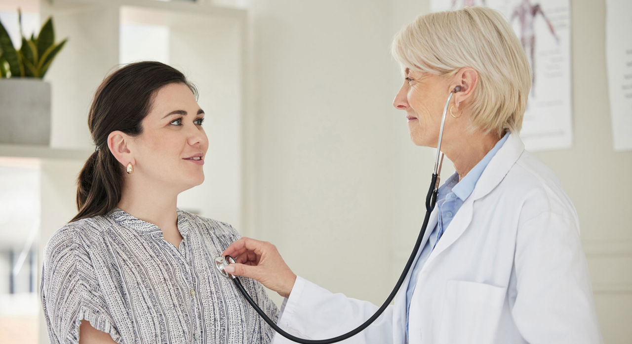 A patient having his blood pressure taken by a nurse.