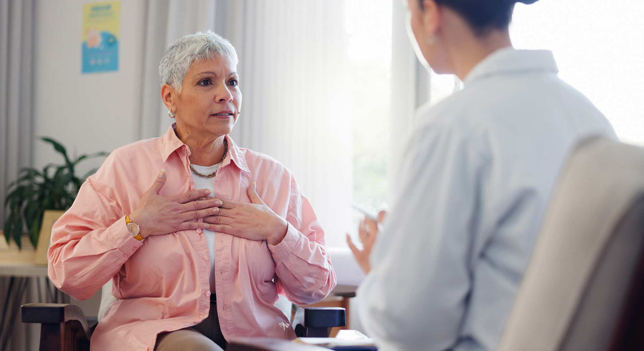 A patient describes heart block symptoms, touching chest and talking to a doctor.