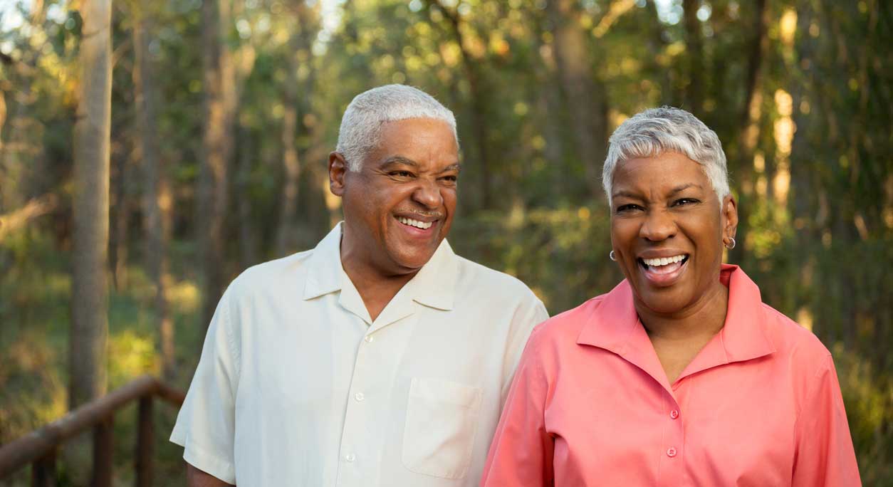 A smiling older couple outdoors.