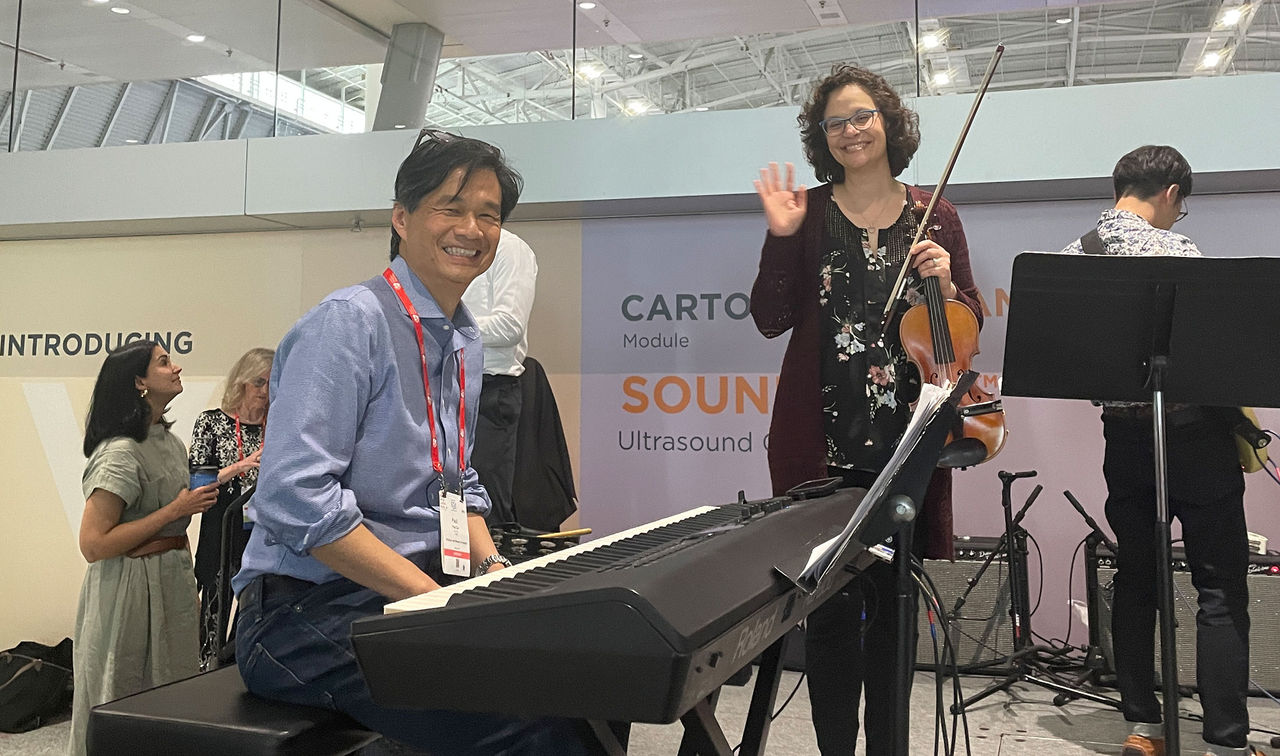 A band rehearsal with a violinist and keyboardist.