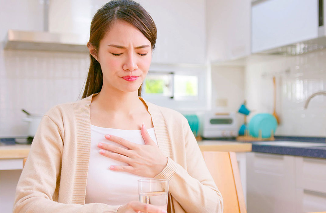 woman with hand on her chest
