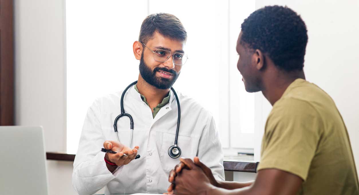 A physician and patient talk in an office.