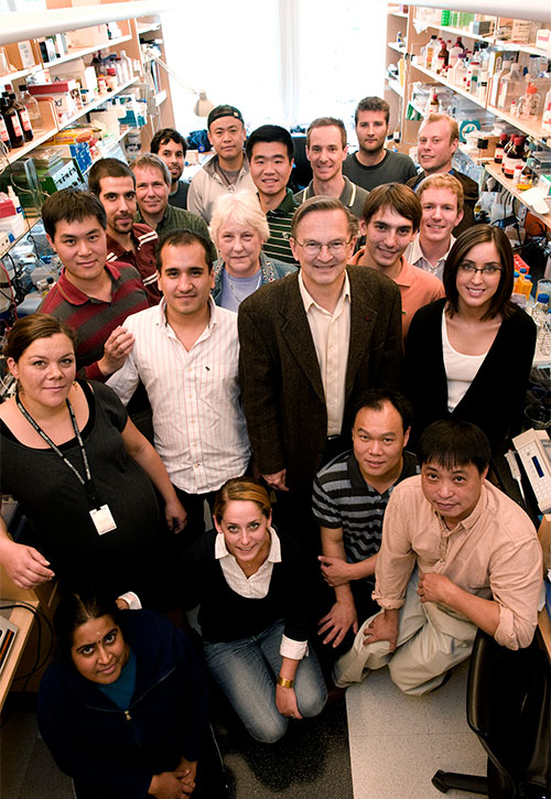A group of lab members standing and smiling together in a group