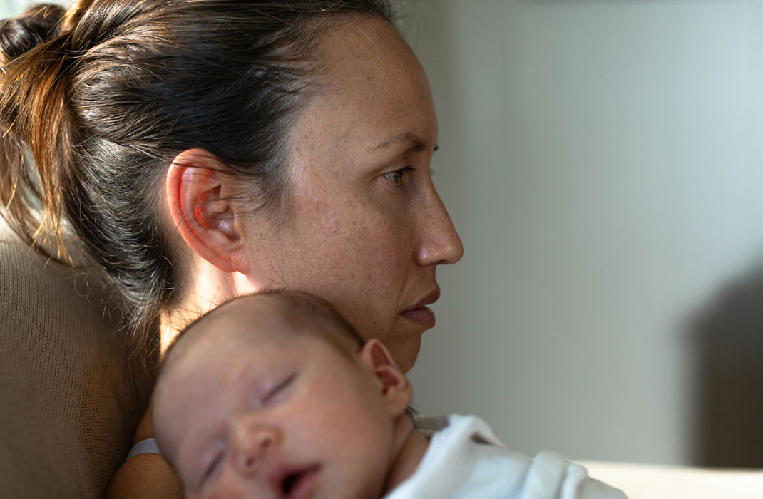 woman holding a sleeping baby