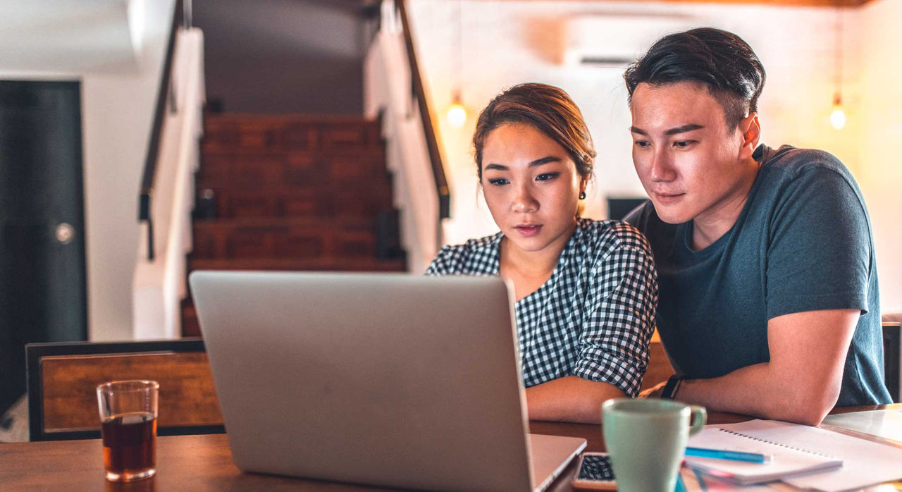 A concerned couple searches the Internet together.