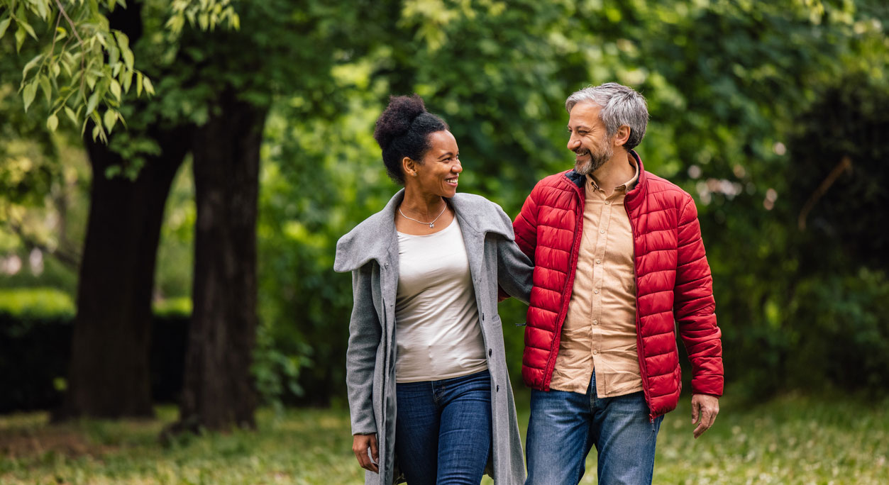 A couple walking together through the countryside.