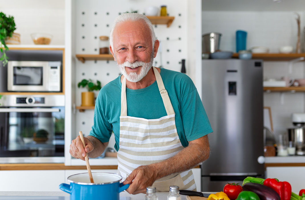 Man cooking with vegetables to lower blood pressure. 