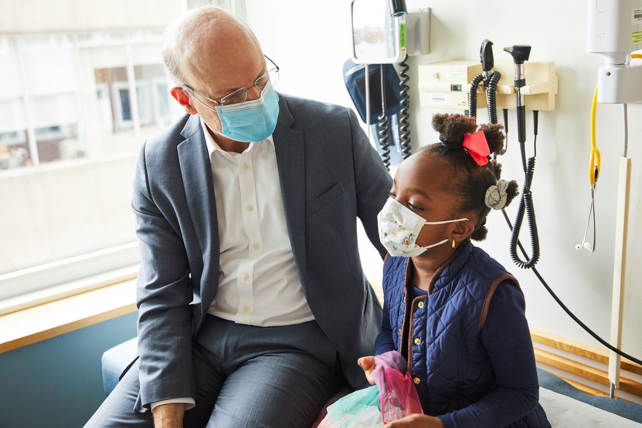 Health care provider working with a patient. Both are wearing masks.