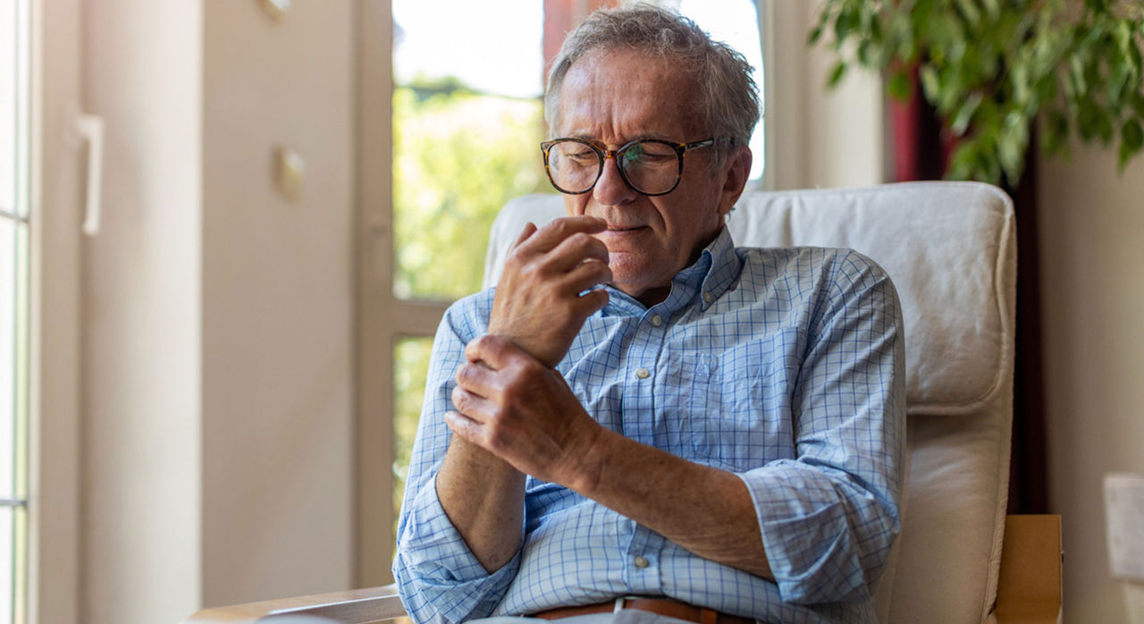 Senior man having pain in his hand from arthritis 
